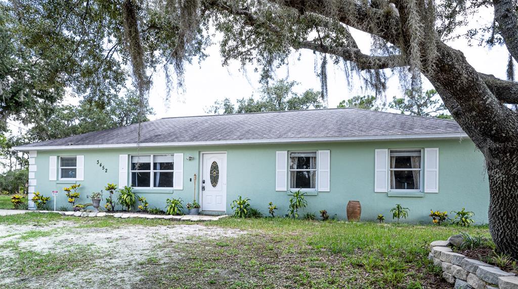 a front view of house with yard and green space