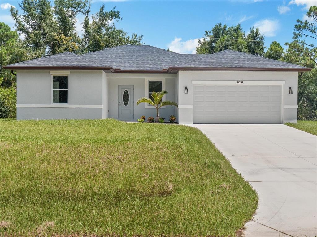 a front view of a house with a yard and garage