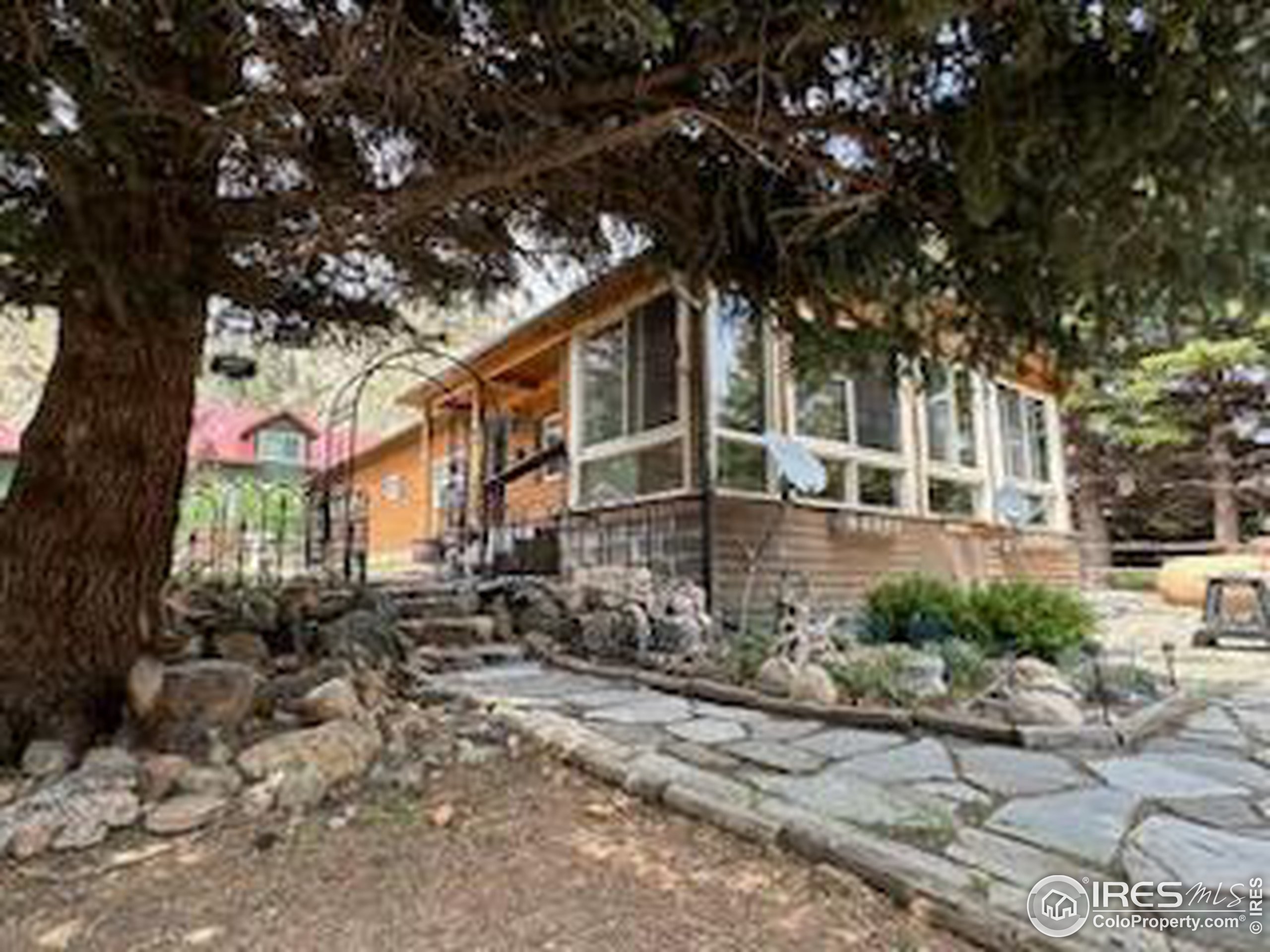 a view of a house with a tree in the yard