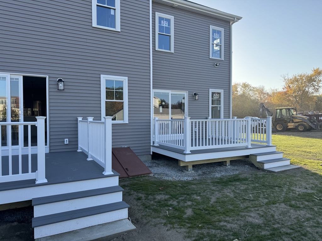 a view of a house with a yard and deck