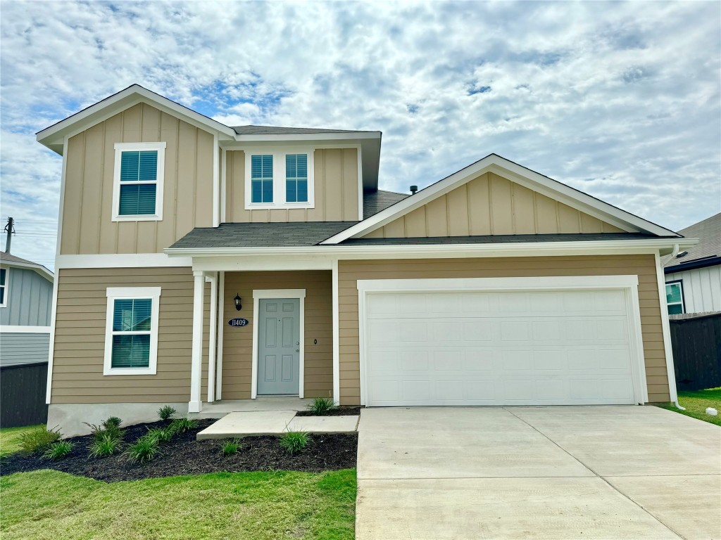 a front view of a house with a yard and garage