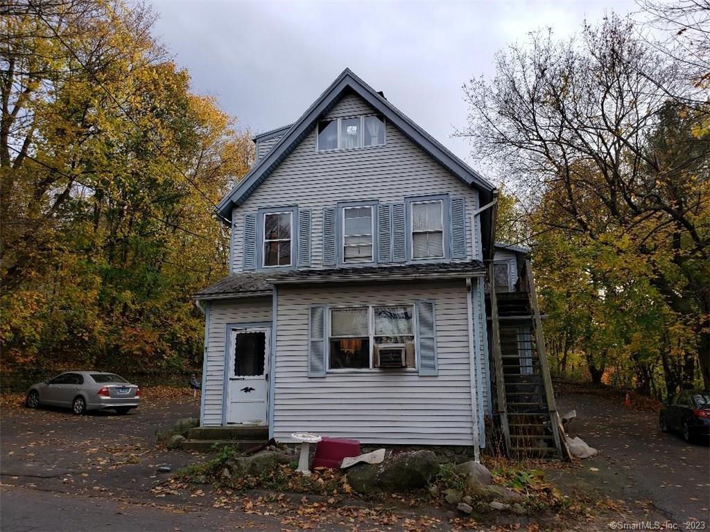 a front view of a house with parking space