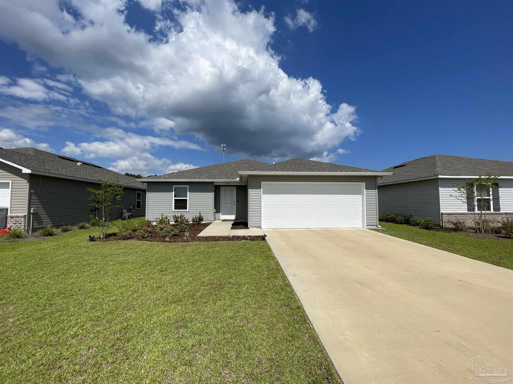 a view of a house with a yard and sitting area