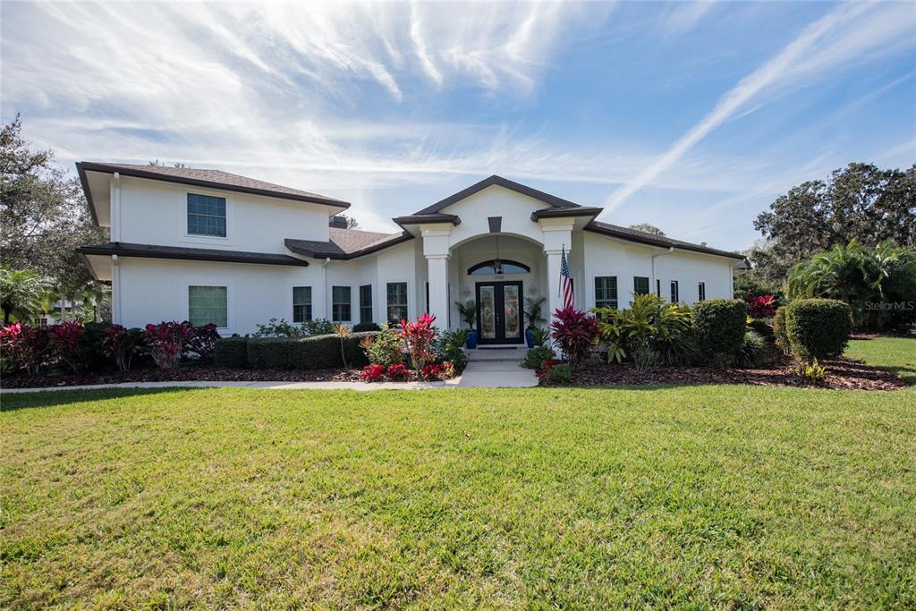 a front view of a house with yard and garage