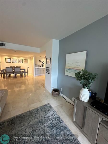 a hallway with a view of living room