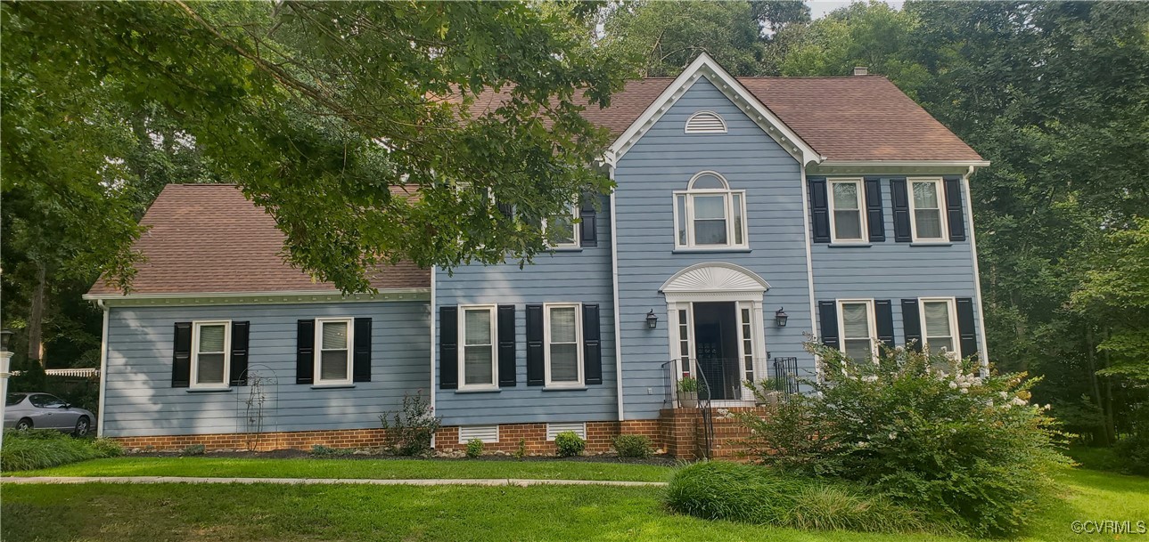 Colonial-style house with a front lawn