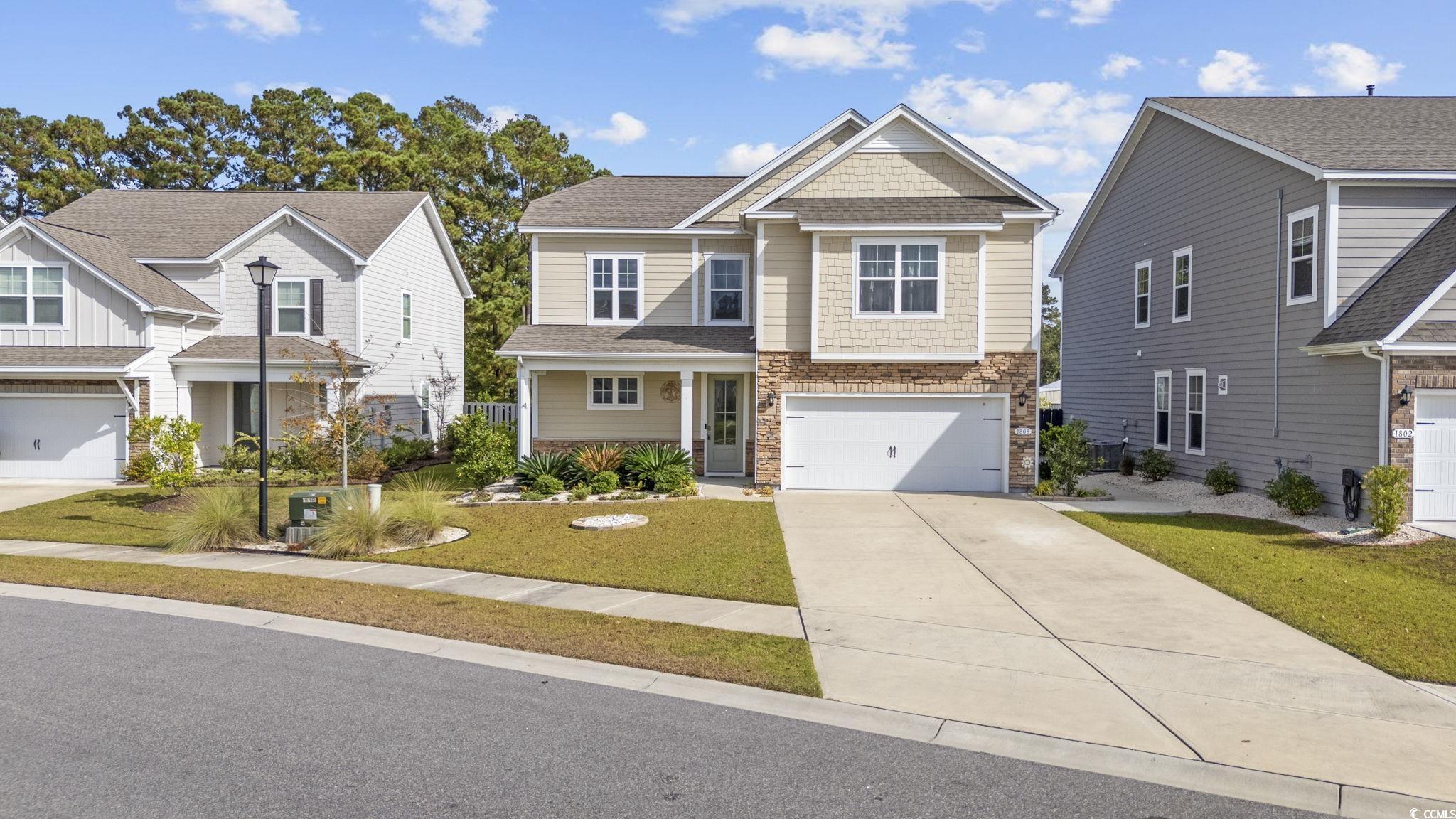 View of front of house featuring a garage and a fr