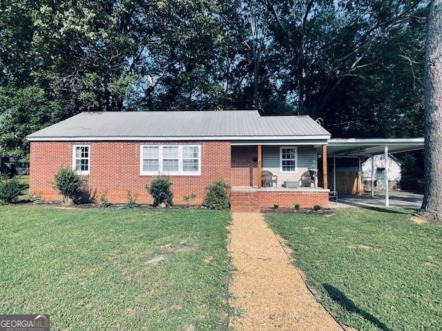 a front view of a house with a yard porch and furniture