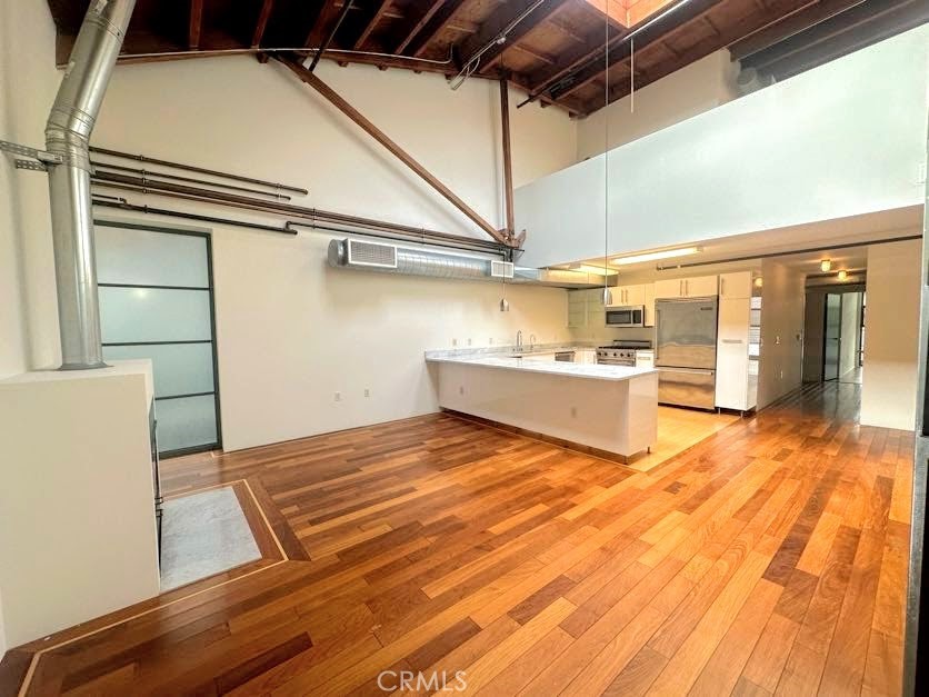 a view of a room with wooden floor