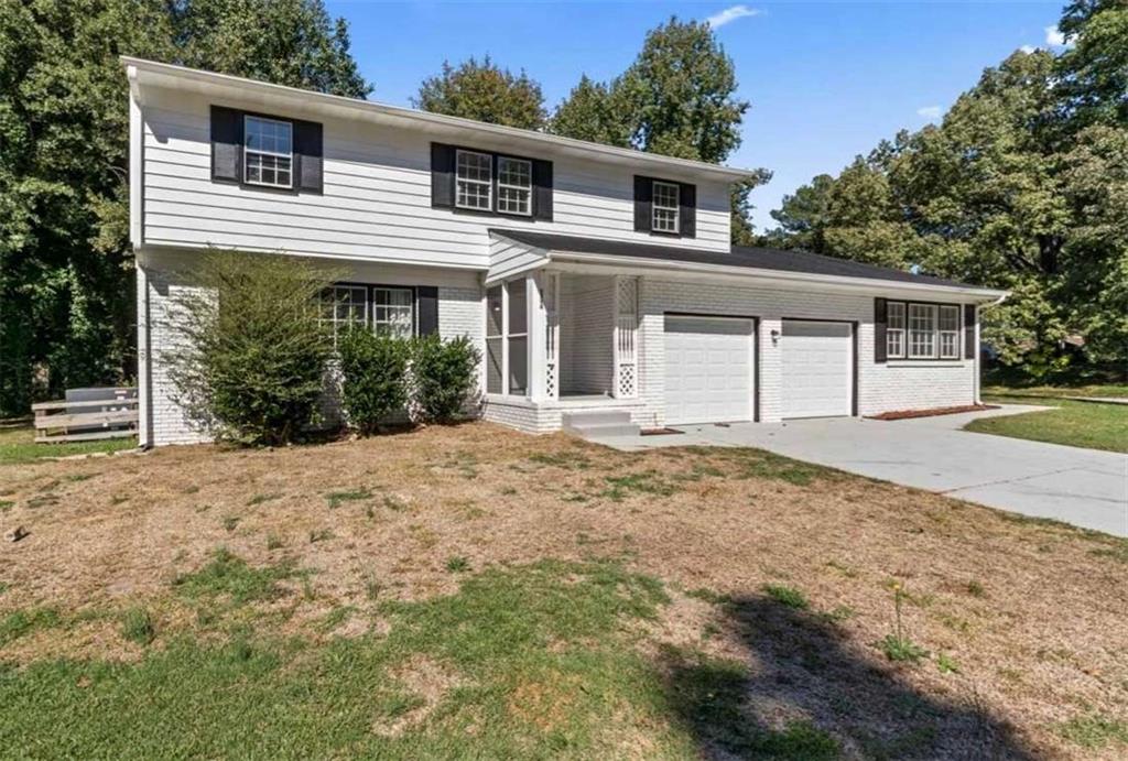 a front view of a house with a yard and garage