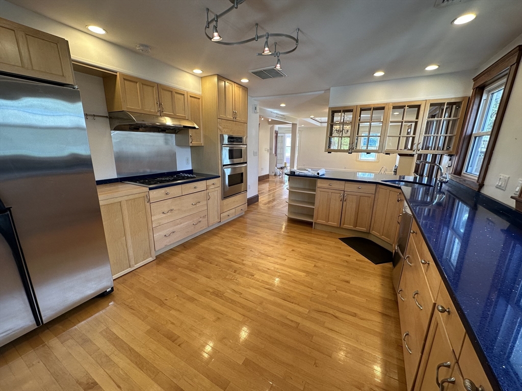 a large kitchen with a large counter top appliances and furniture