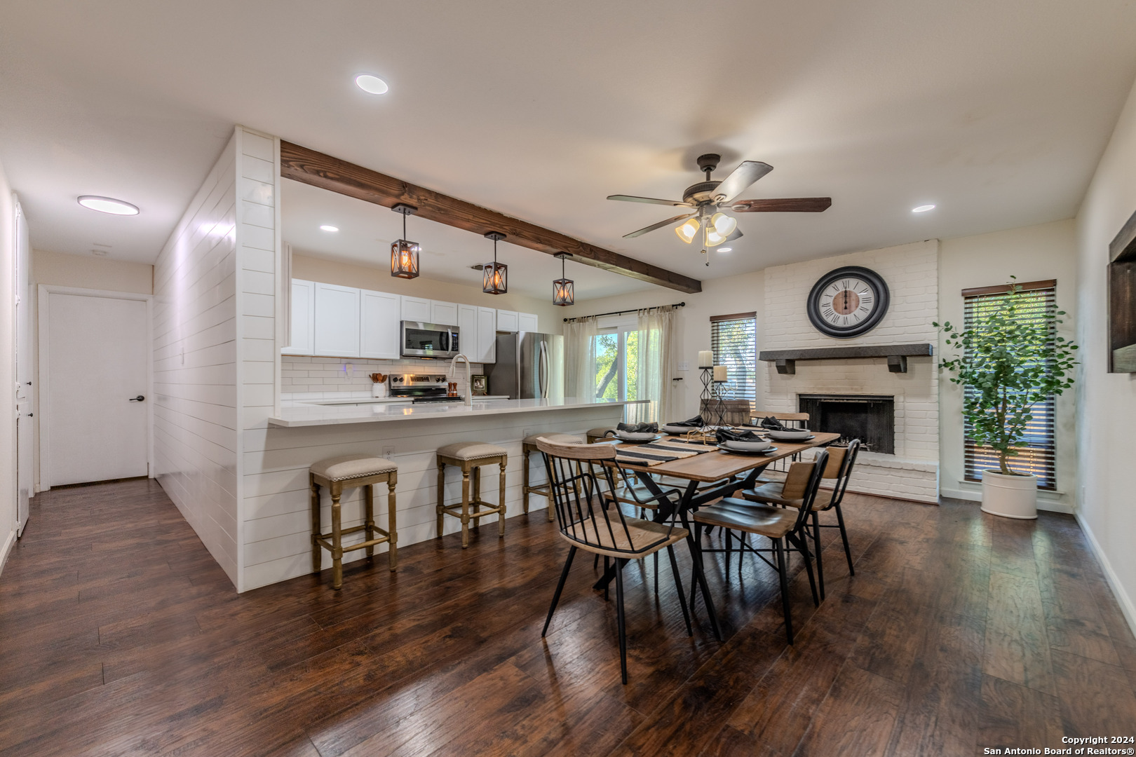 a view of a dining room with furniture and wooden floor