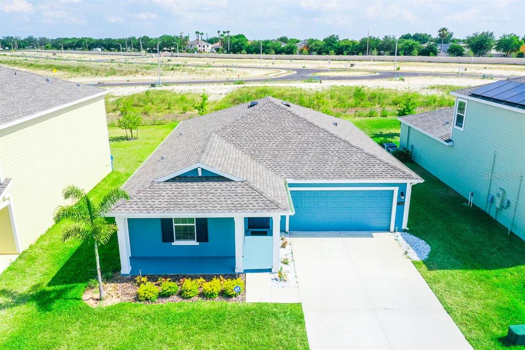 a view of house with a yard and a large pool