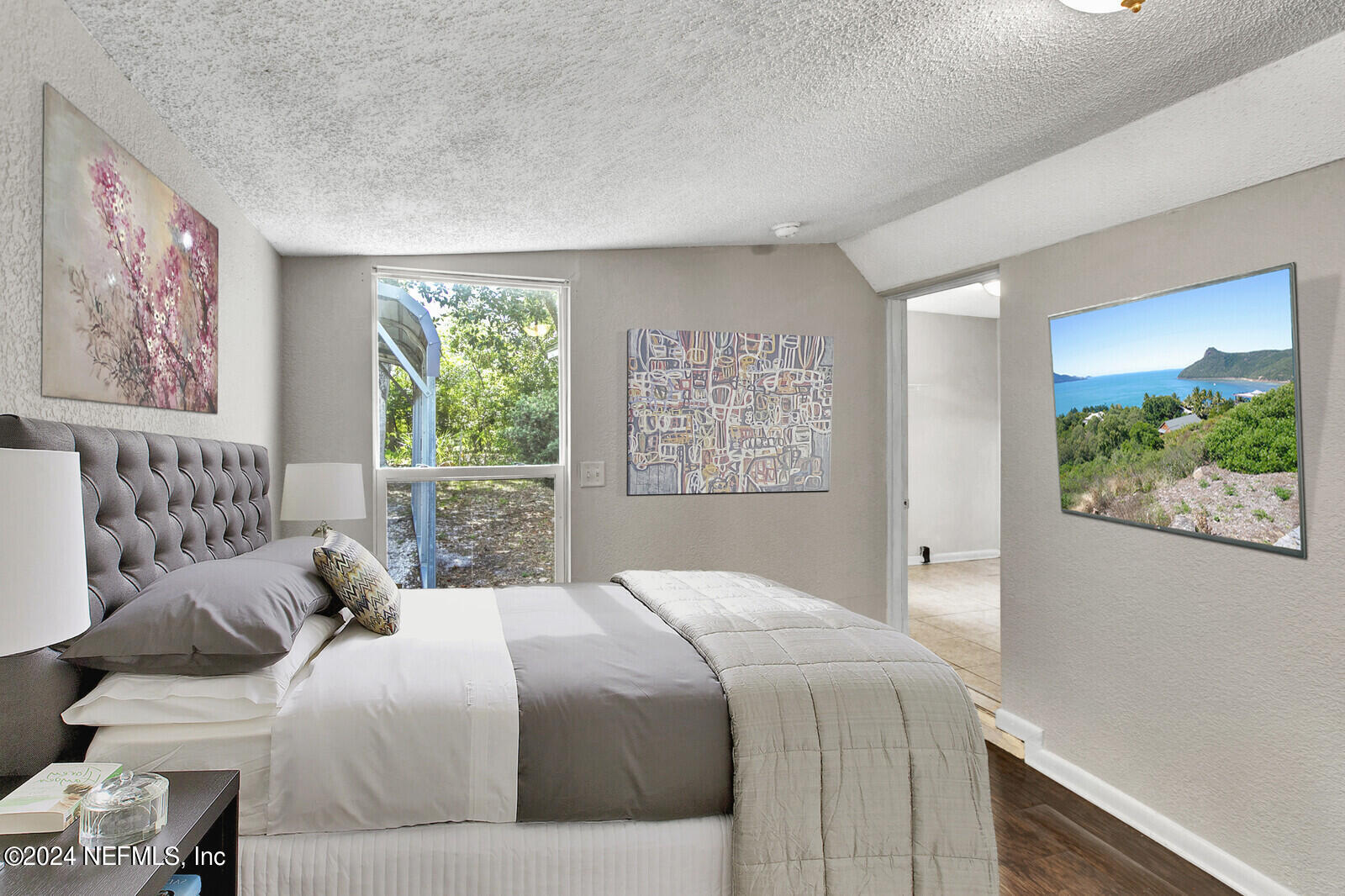 a bedroom with a large bed and a window