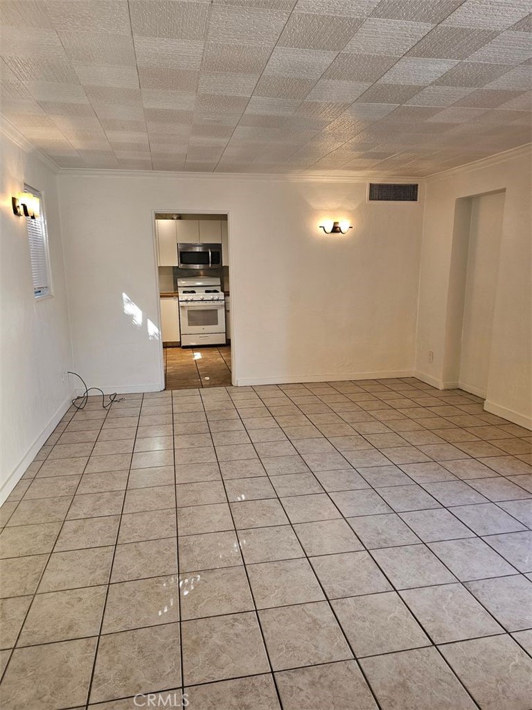 a view of a livingroom with an empty space and a sink cabinets