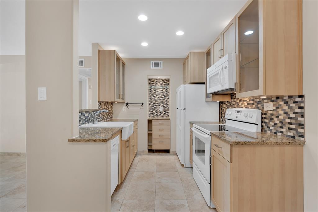 a kitchen with a sink stove and refrigerator