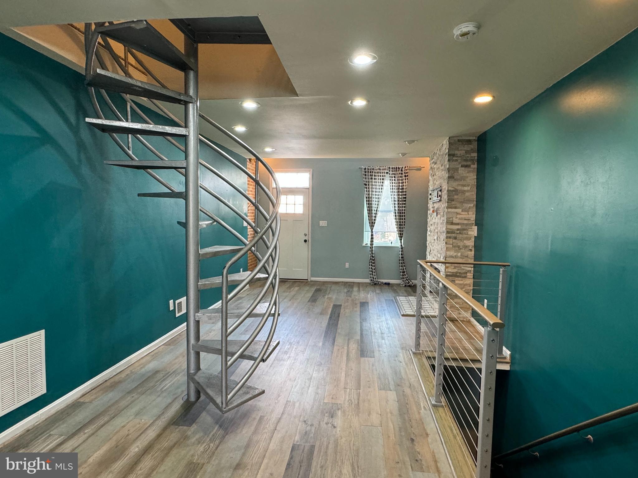 a view of entryway and hall with wooden floor