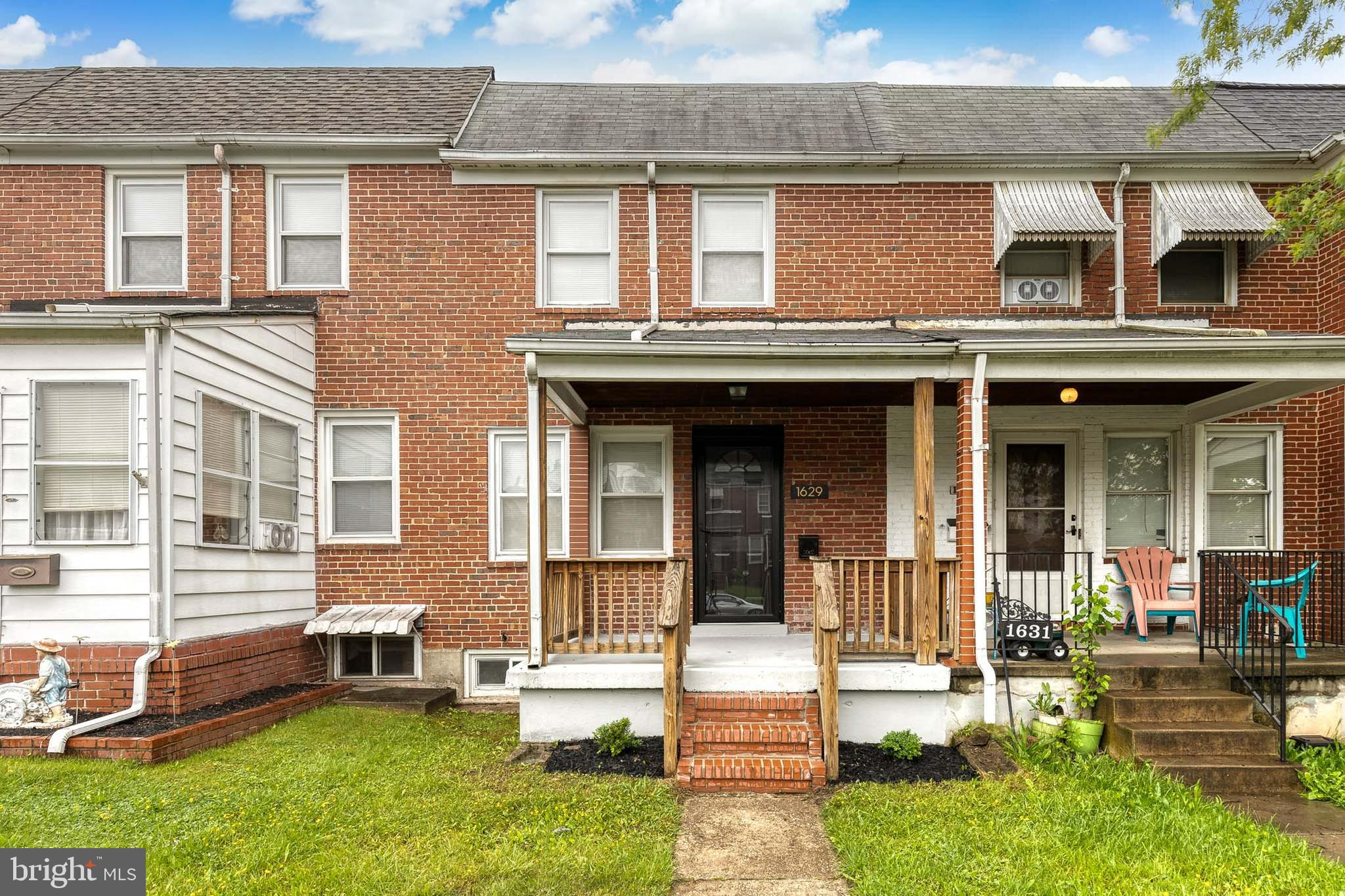 front view of a brick house with a yard