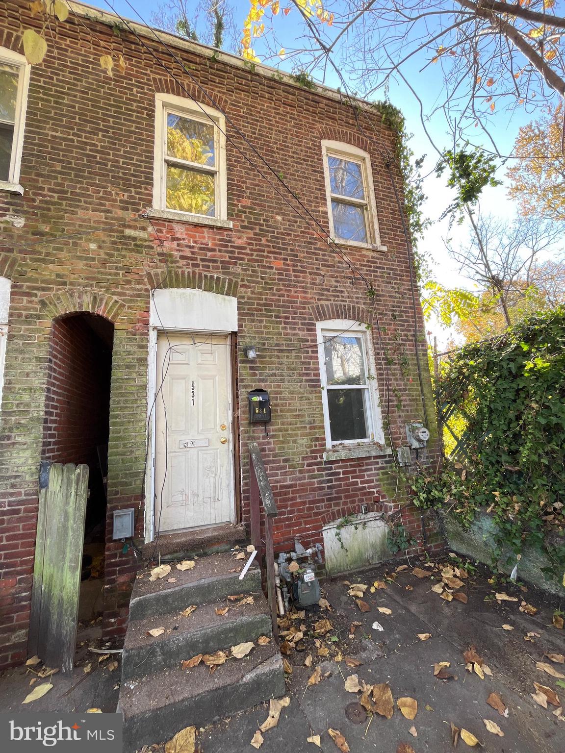 a brick building with a bench and a shower