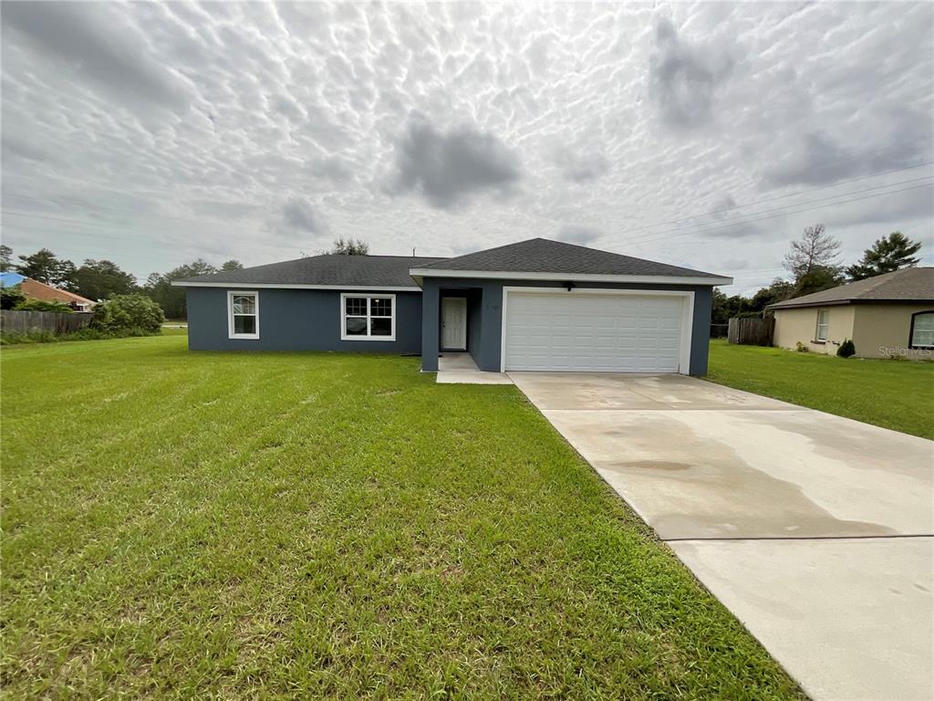 a view of a house with a yard