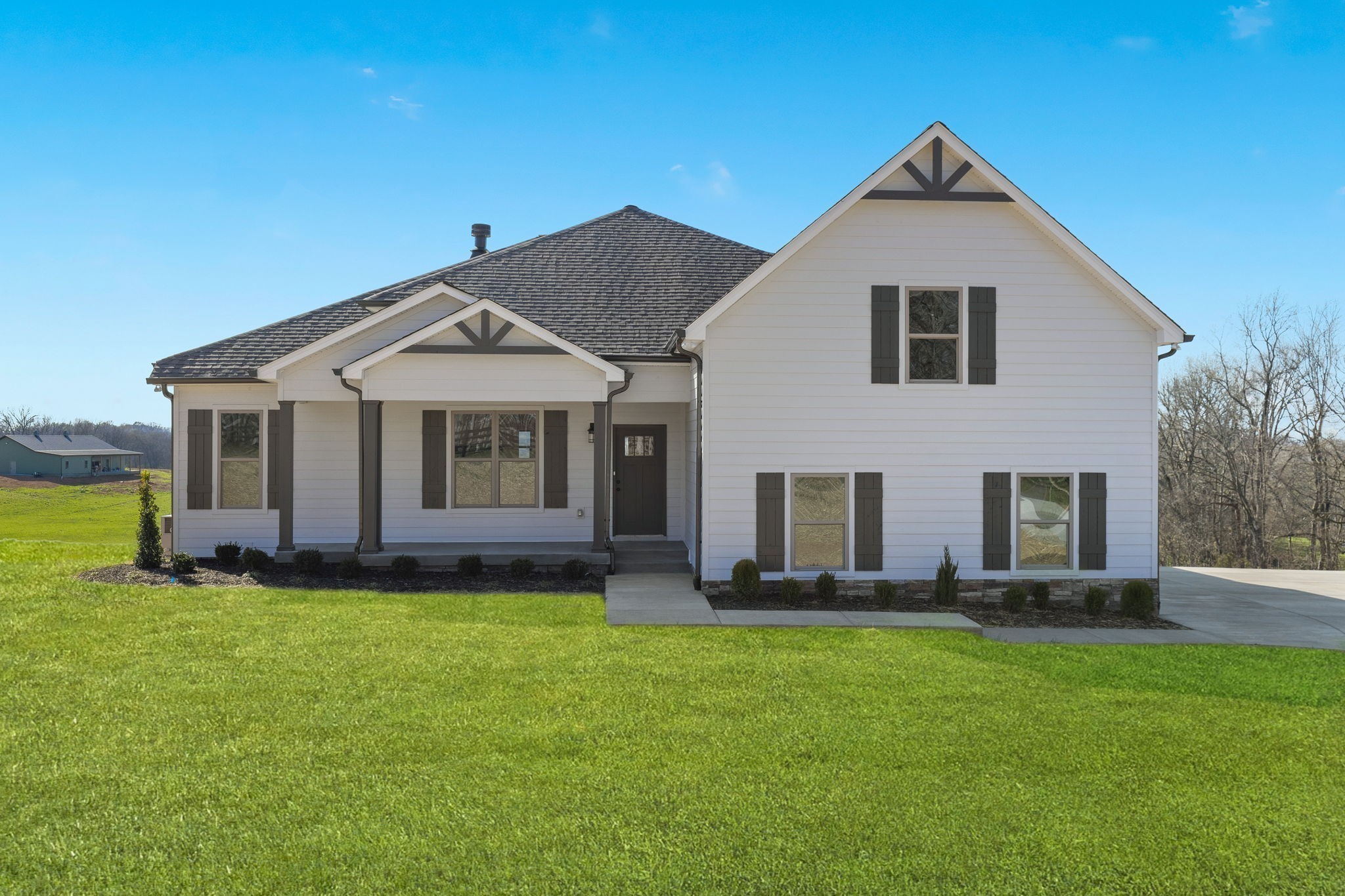 a front view of a house with a garden