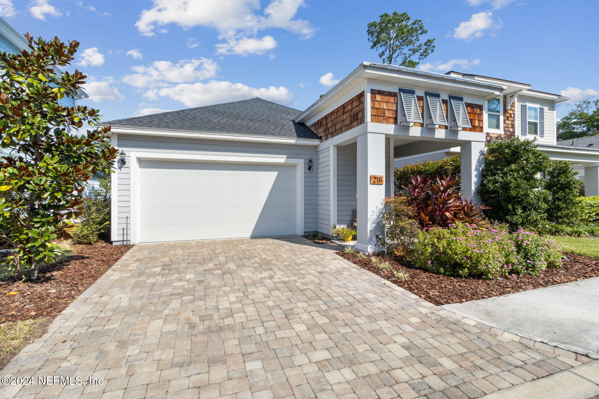 a front view of a house with garden