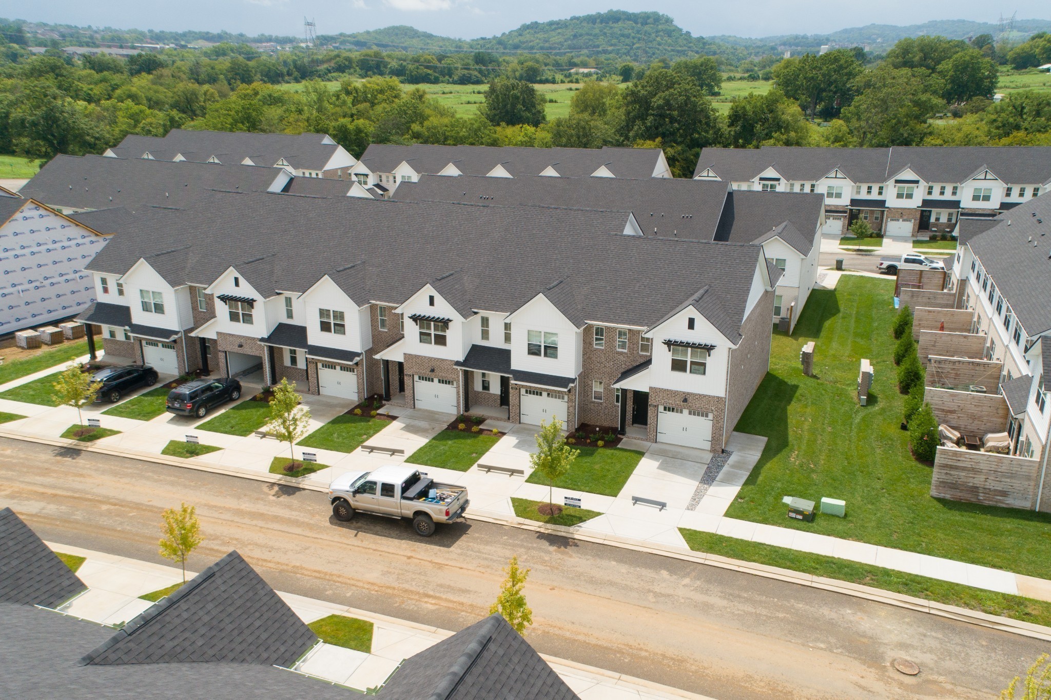 an aerial view of a house with a garden and lake view