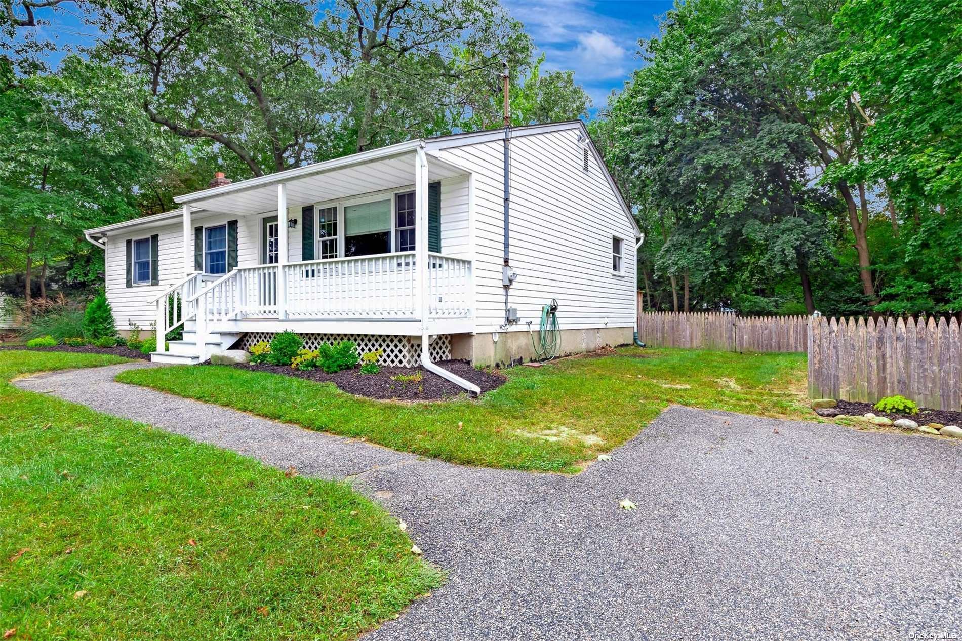 a view of a house with a yard and fence