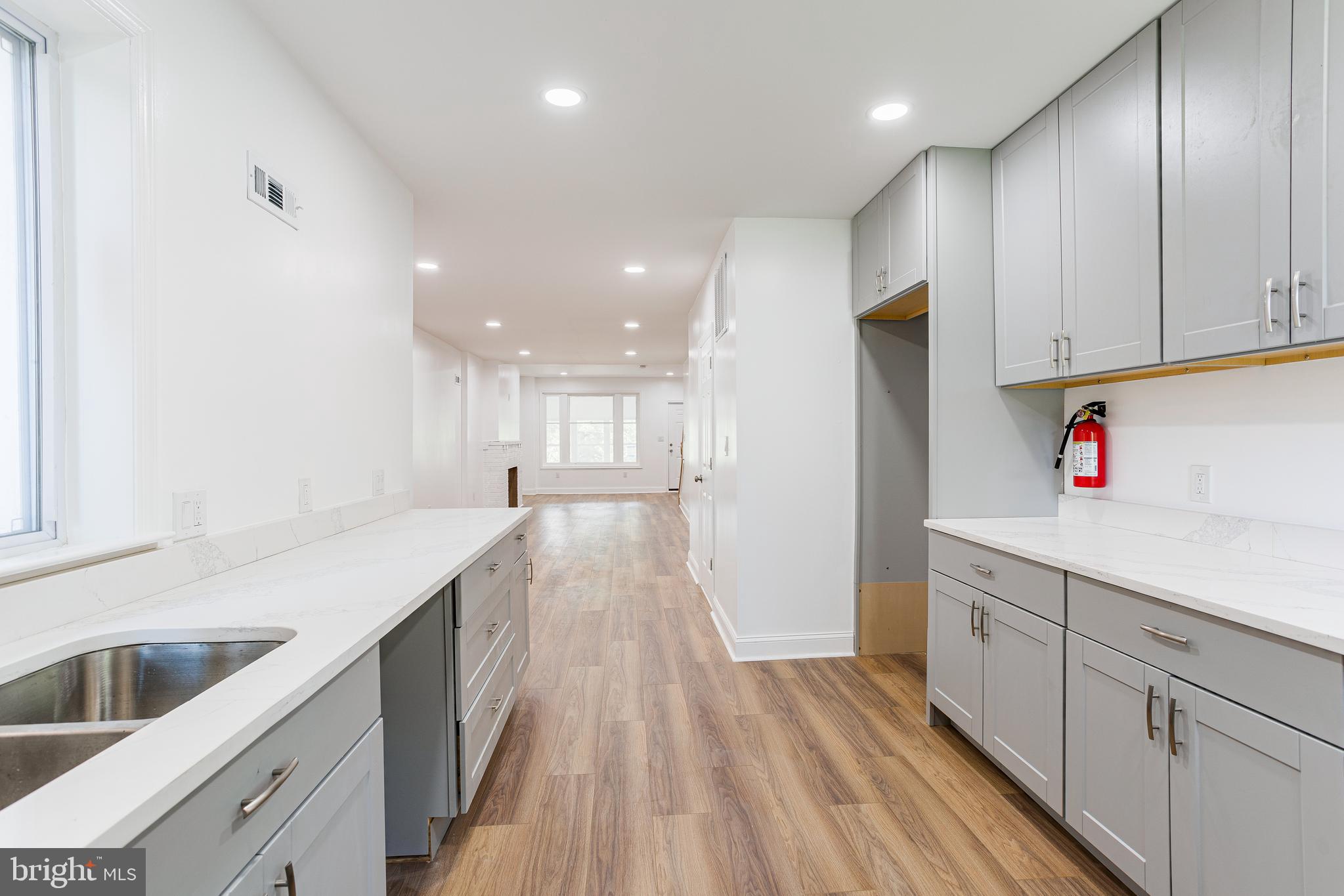 a kitchen with granite countertop white cabinets and white appliances