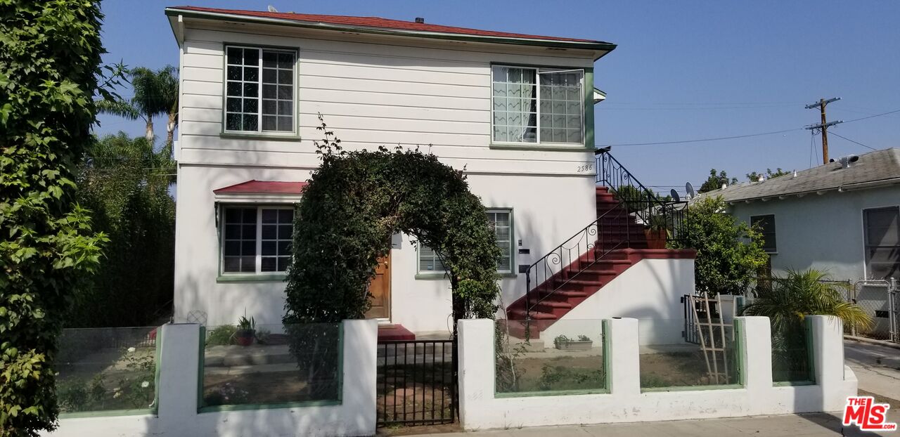 a house that has a tree in front of the house