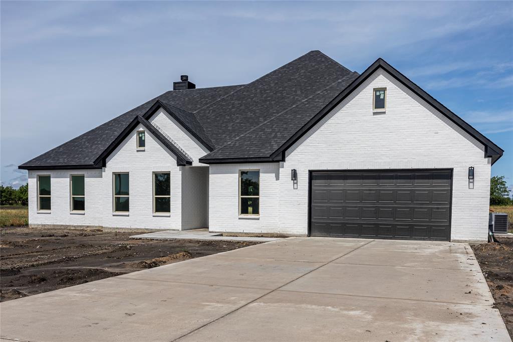 a front view of a house with a garage