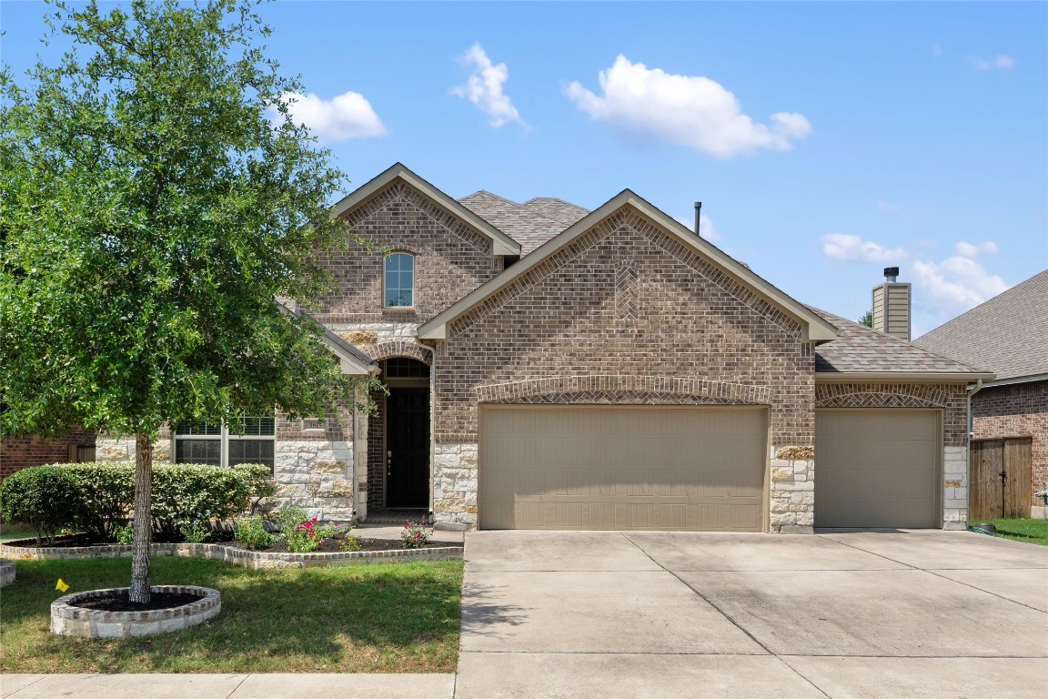 a front view of a house with a yard and garage