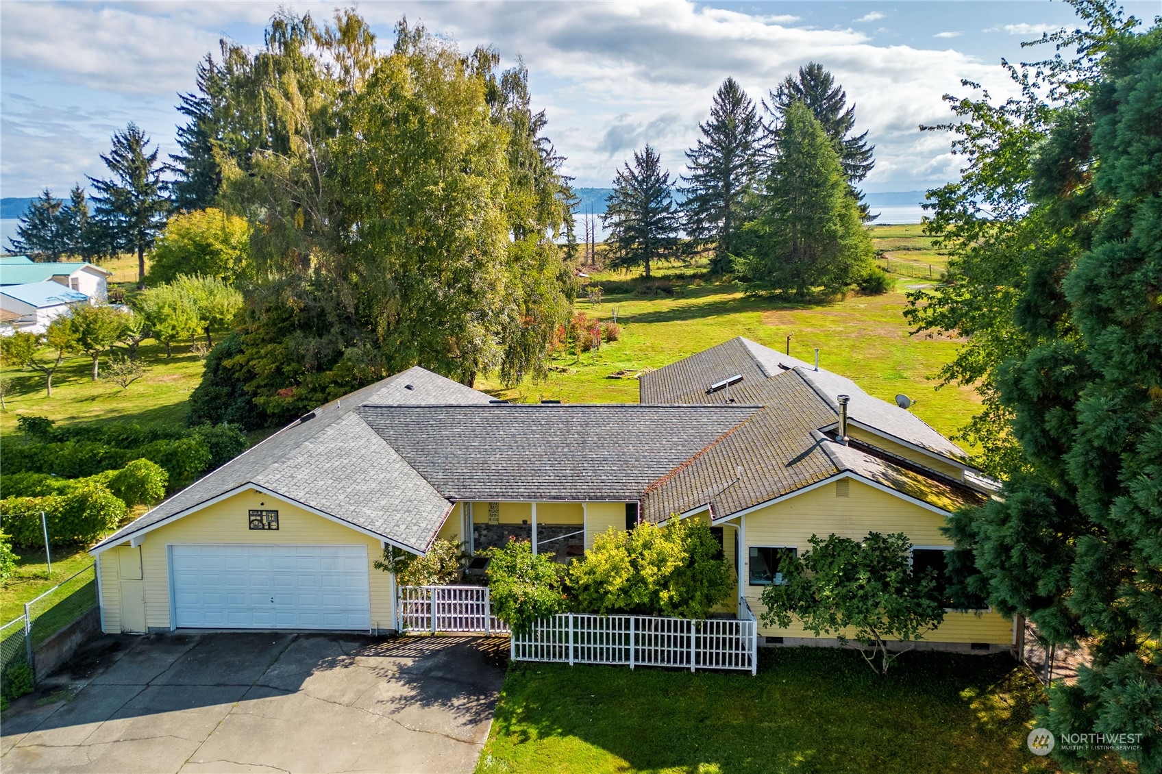 a aerial view of a house next to a yard