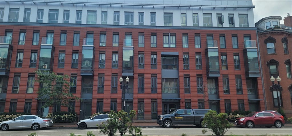 a car parked in front of a brick building