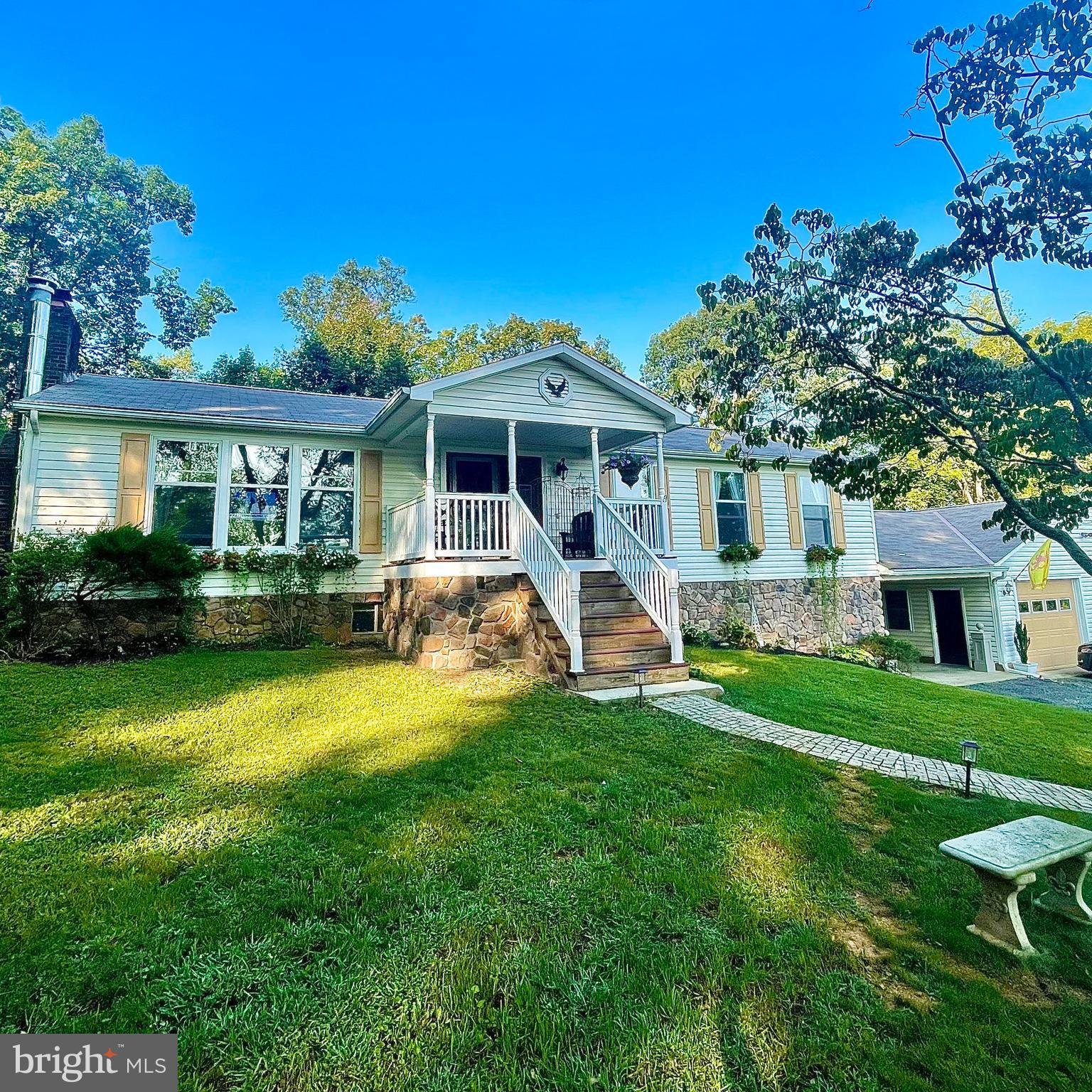 a view of a house with a yard porch and sitting area