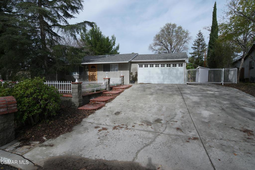 a view of a house with a yard and tree s