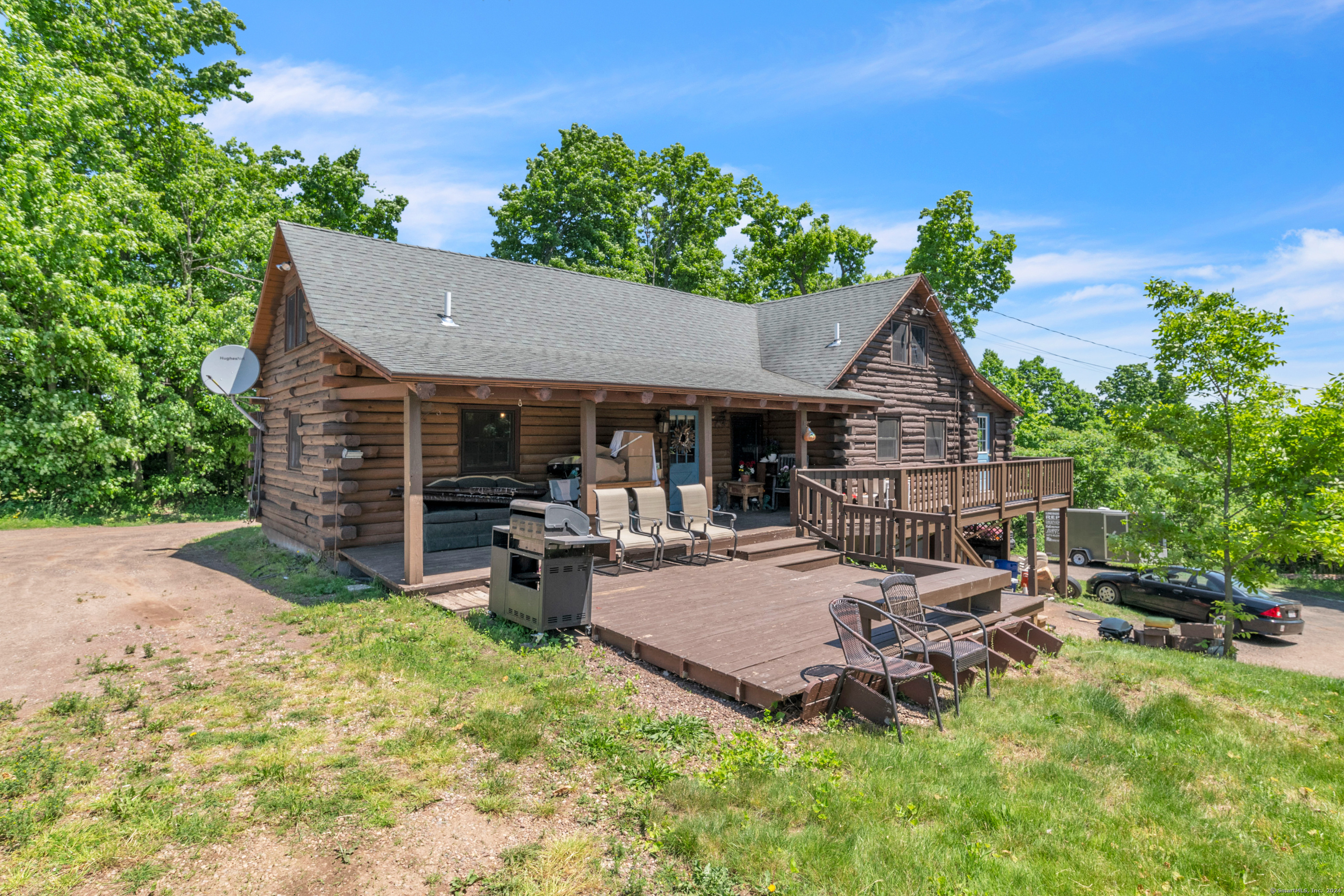 a view of a house with backyard and sitting area