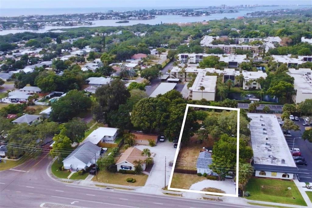 an aerial view of house with yard swimming pool and ocean view