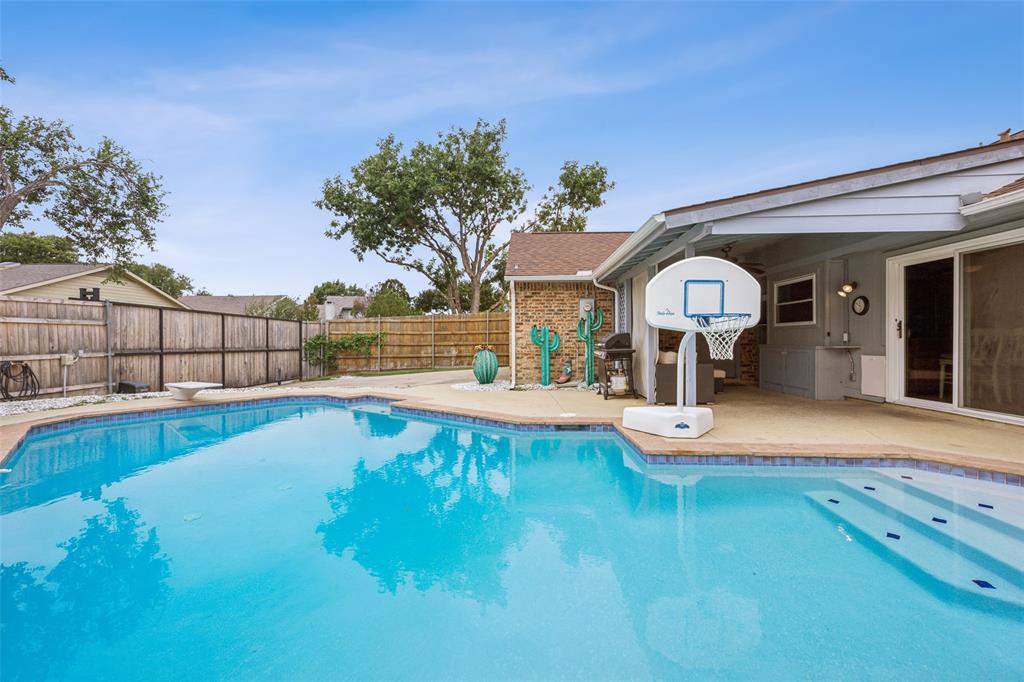 a view of a backyard with swimming pool