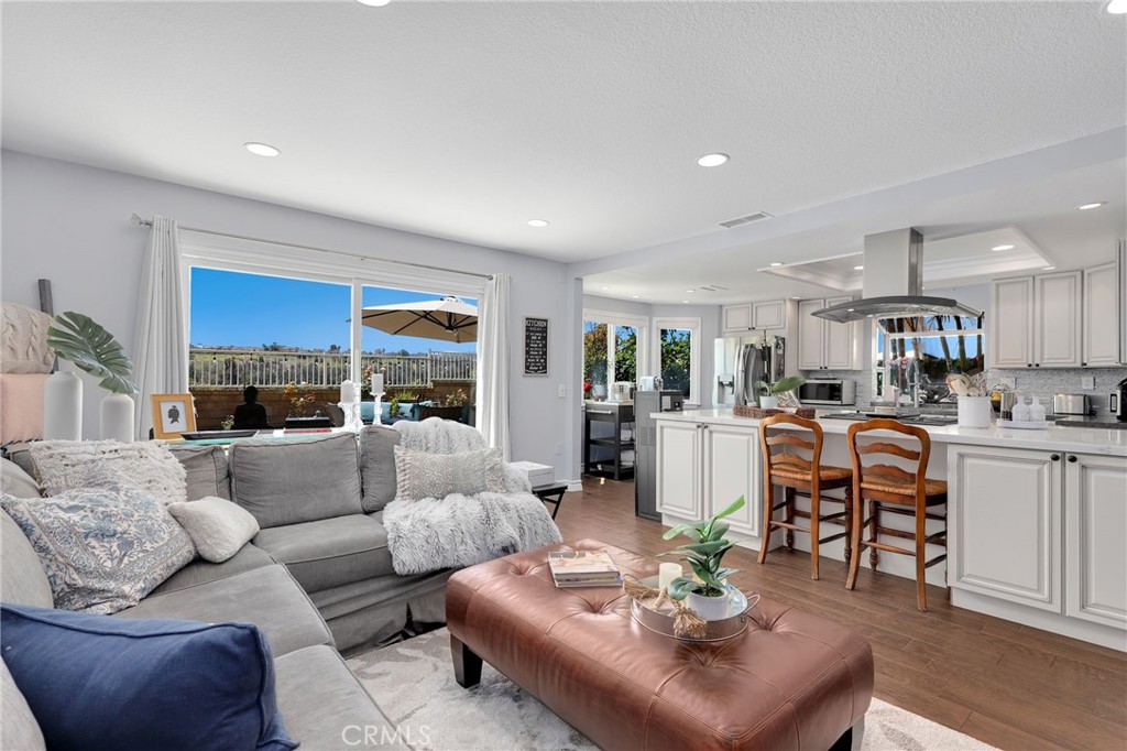 a living room with furniture kitchen view and a table