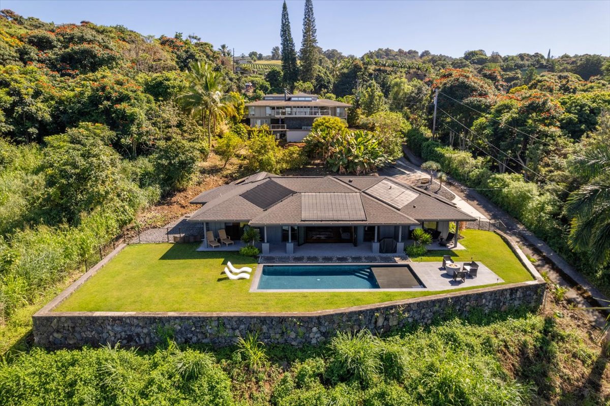 a swimming pool view with a seating space and a garden view