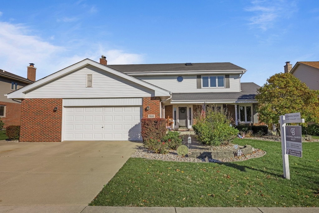 a front view of a house with a yard and garage