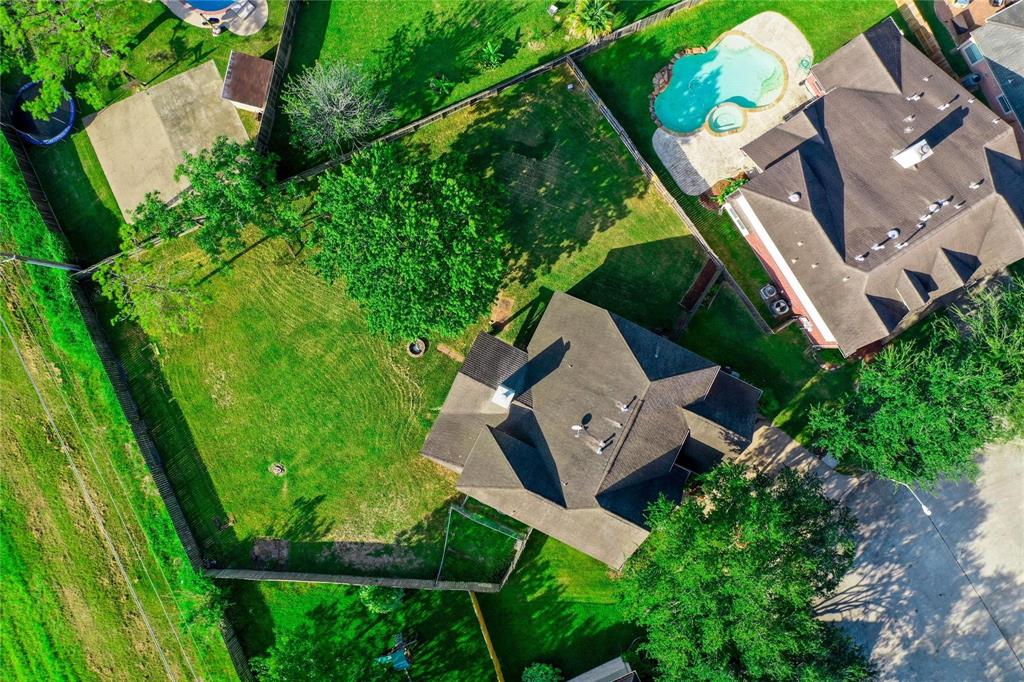 an aerial view of a house with a garden and trees