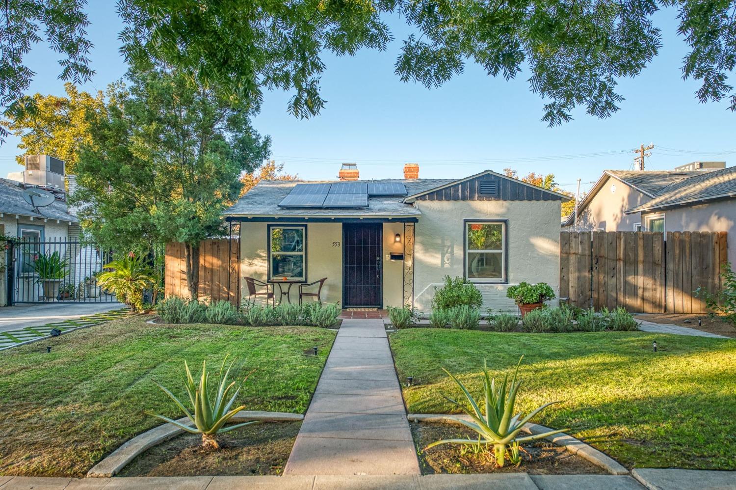 a front view of a house with garden