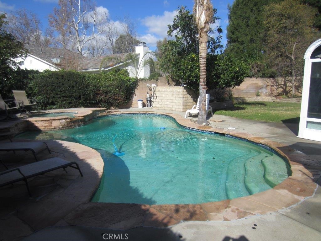 a view of a swimming pool with a yard