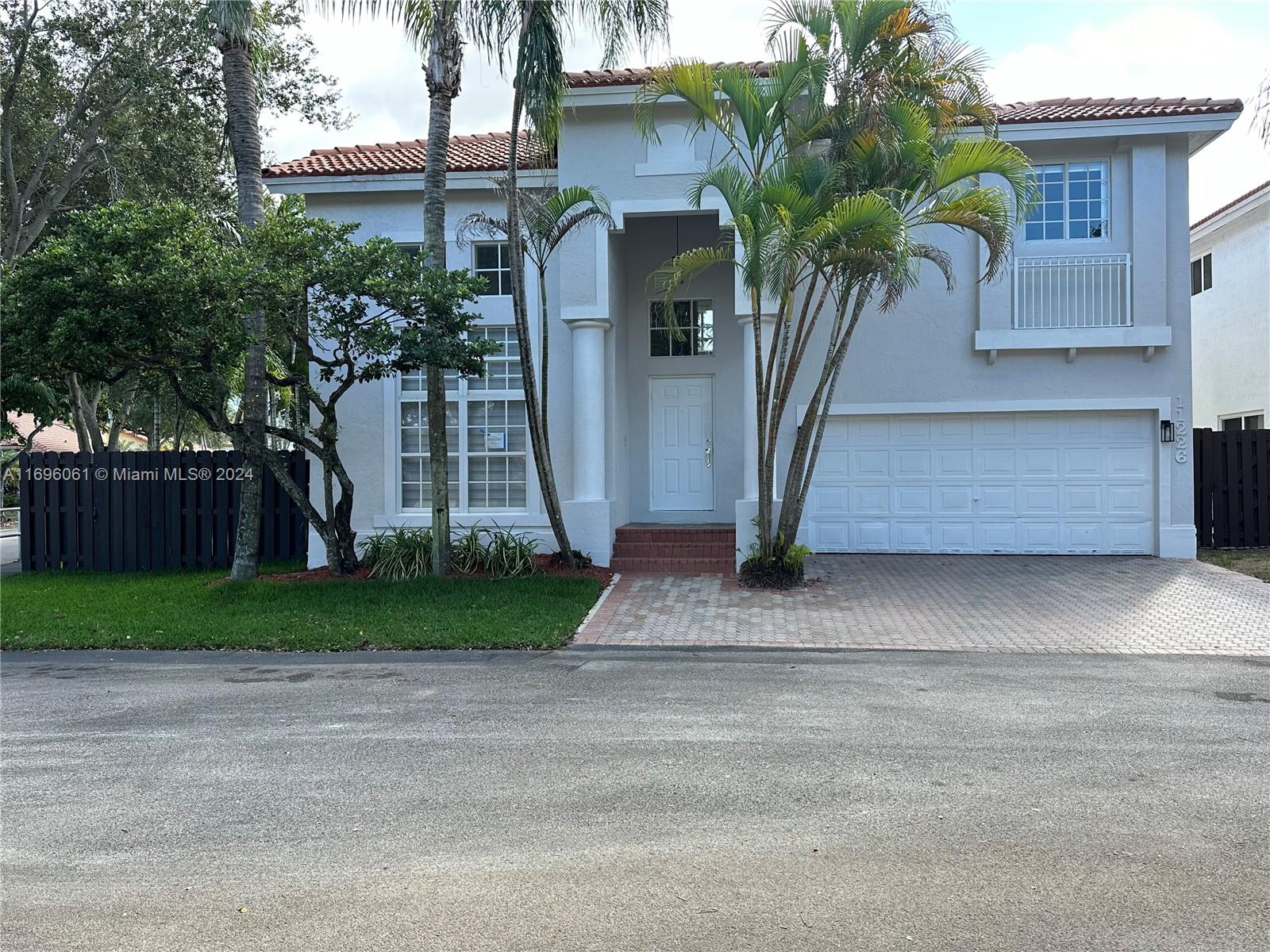 a front view of house with small garden