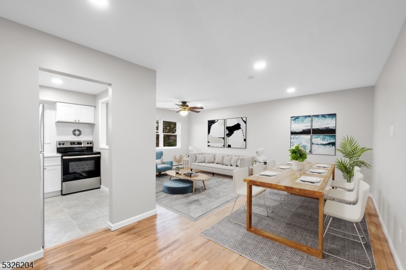 a living room with furniture and a kitchen view