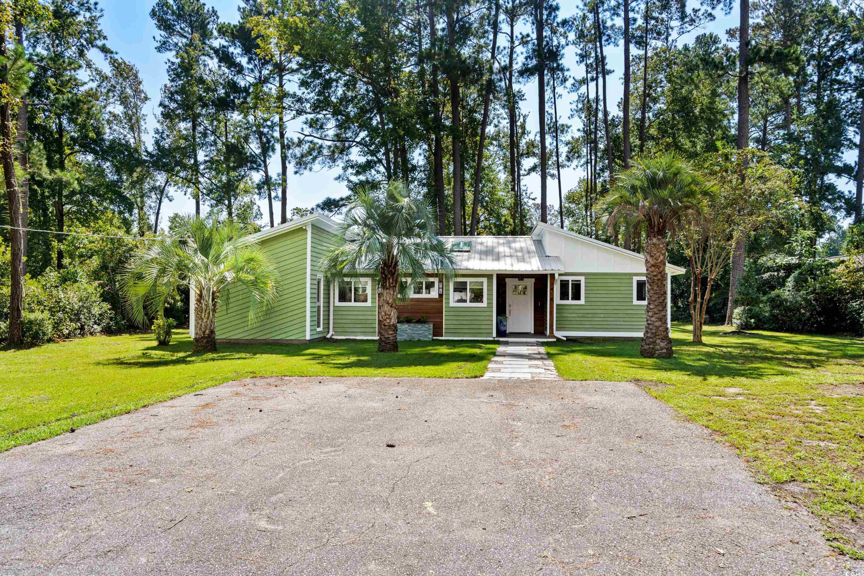 Ranch-style home featuring a front yard