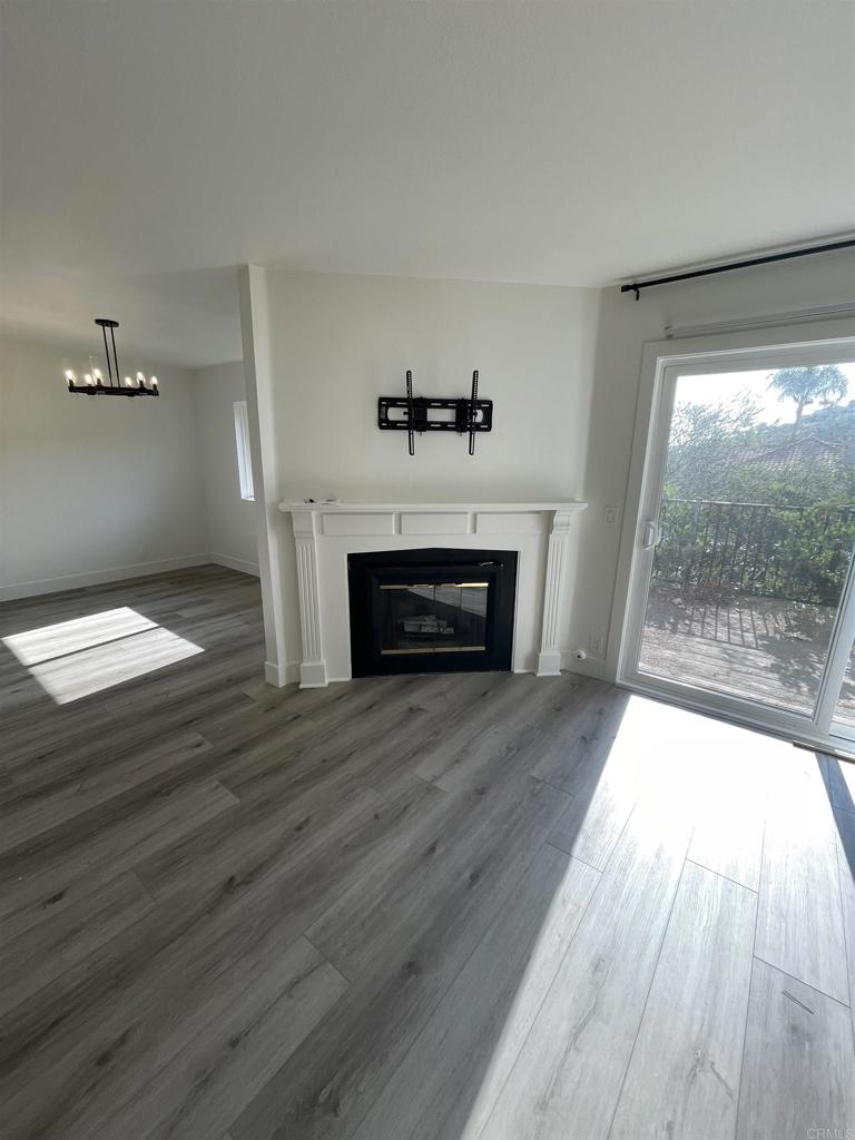 wooden floor in an empty room with a fireplace