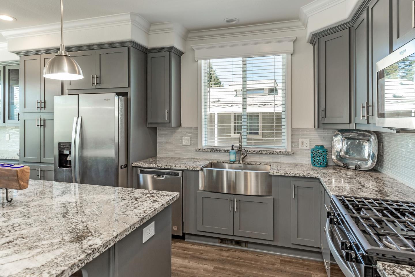 a kitchen with stainless steel appliances granite countertop a sink stove and refrigerator